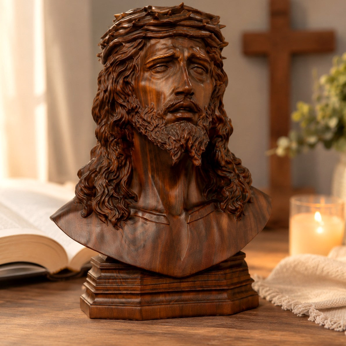 Carved boxwood bust of Jesus wearing the crown of thorns, front view on a wooden table