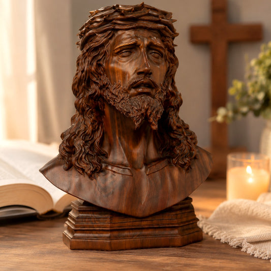 Carved boxwood bust of Jesus wearing the crown of thorns, front view on a wooden table