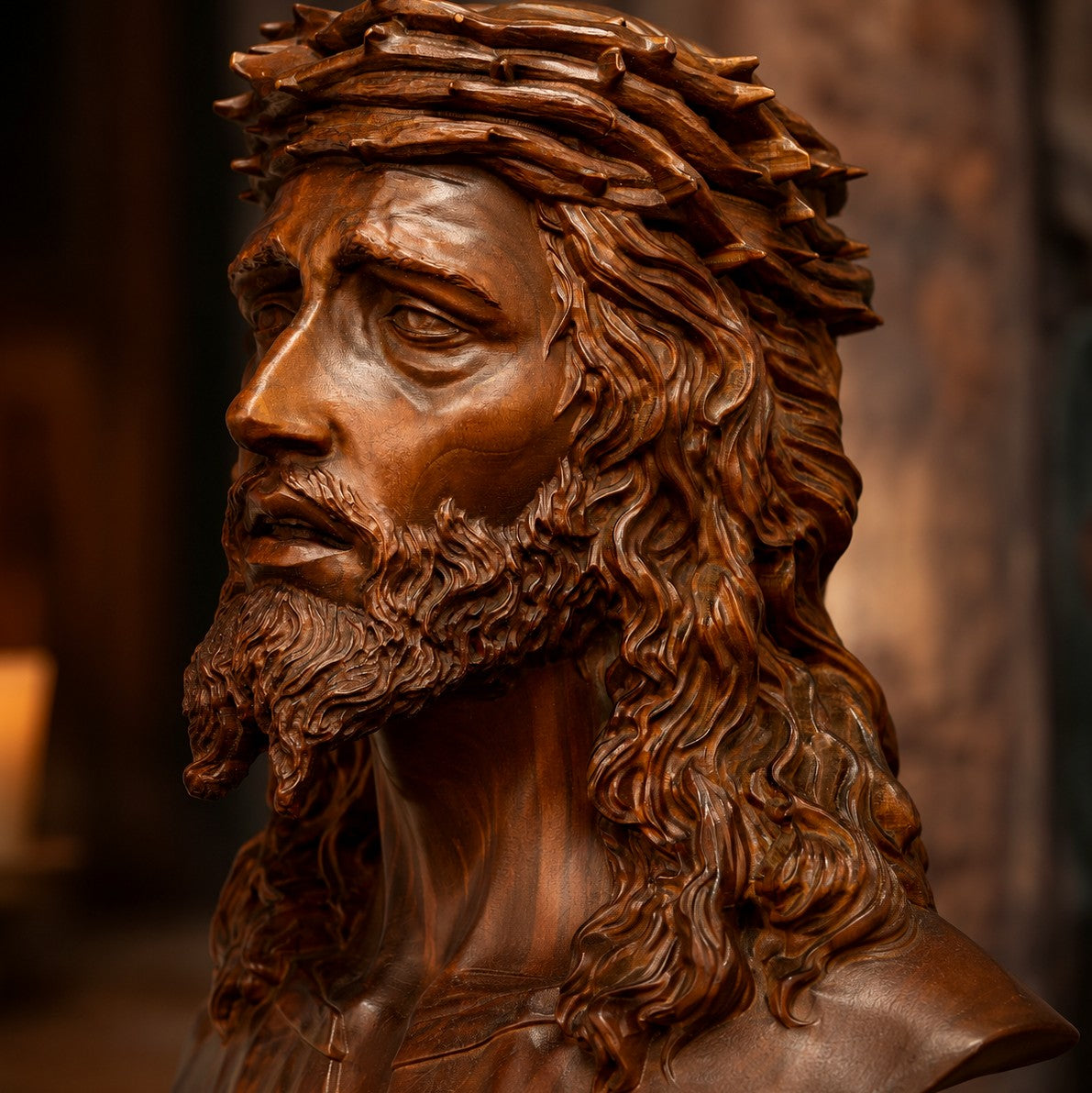 Macro detail of the carved Jesus bust in candlelight showing wood grain and hand-applied finish