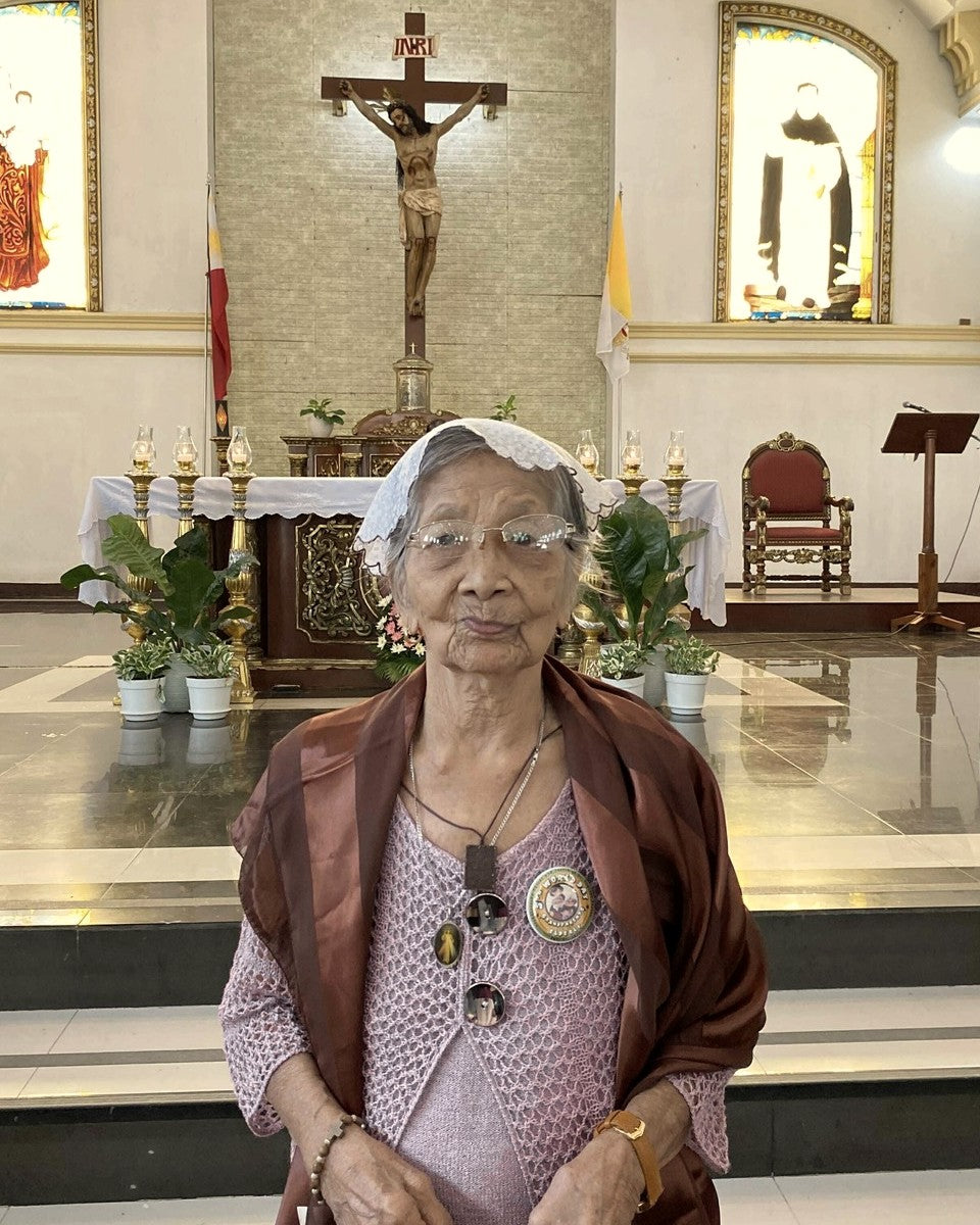 Natividad, the founder's grandmother, before the crucifix at her parish — the faith that began Hewn & Holy.