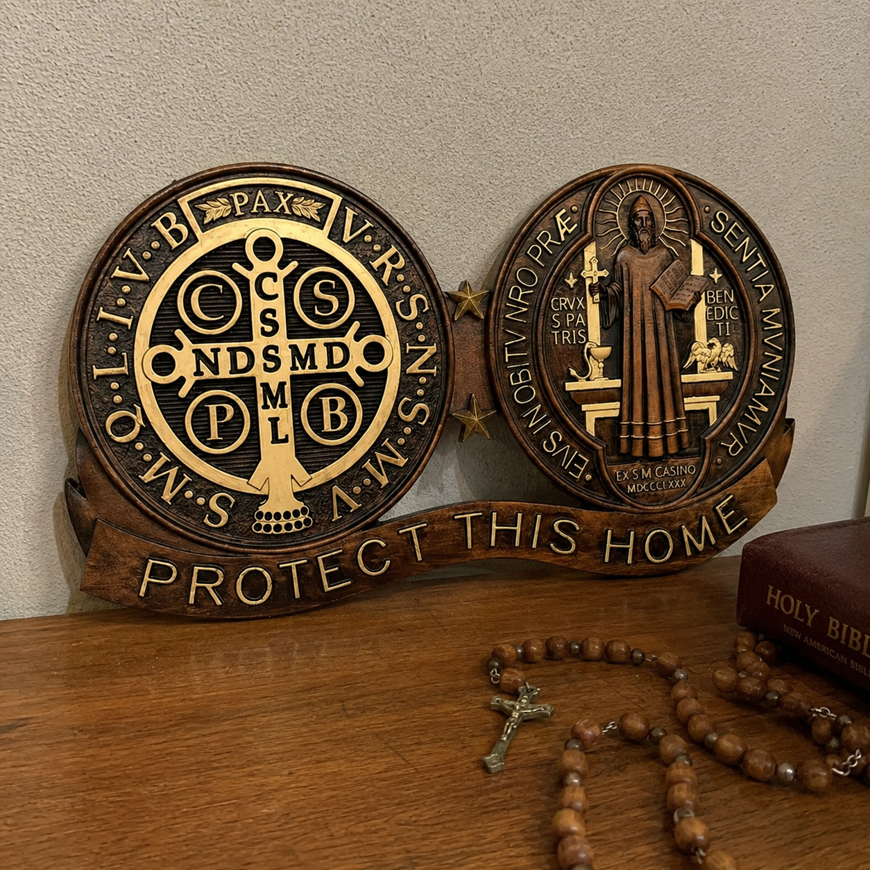 St. Benedict medal carving on an open bible with a rosary