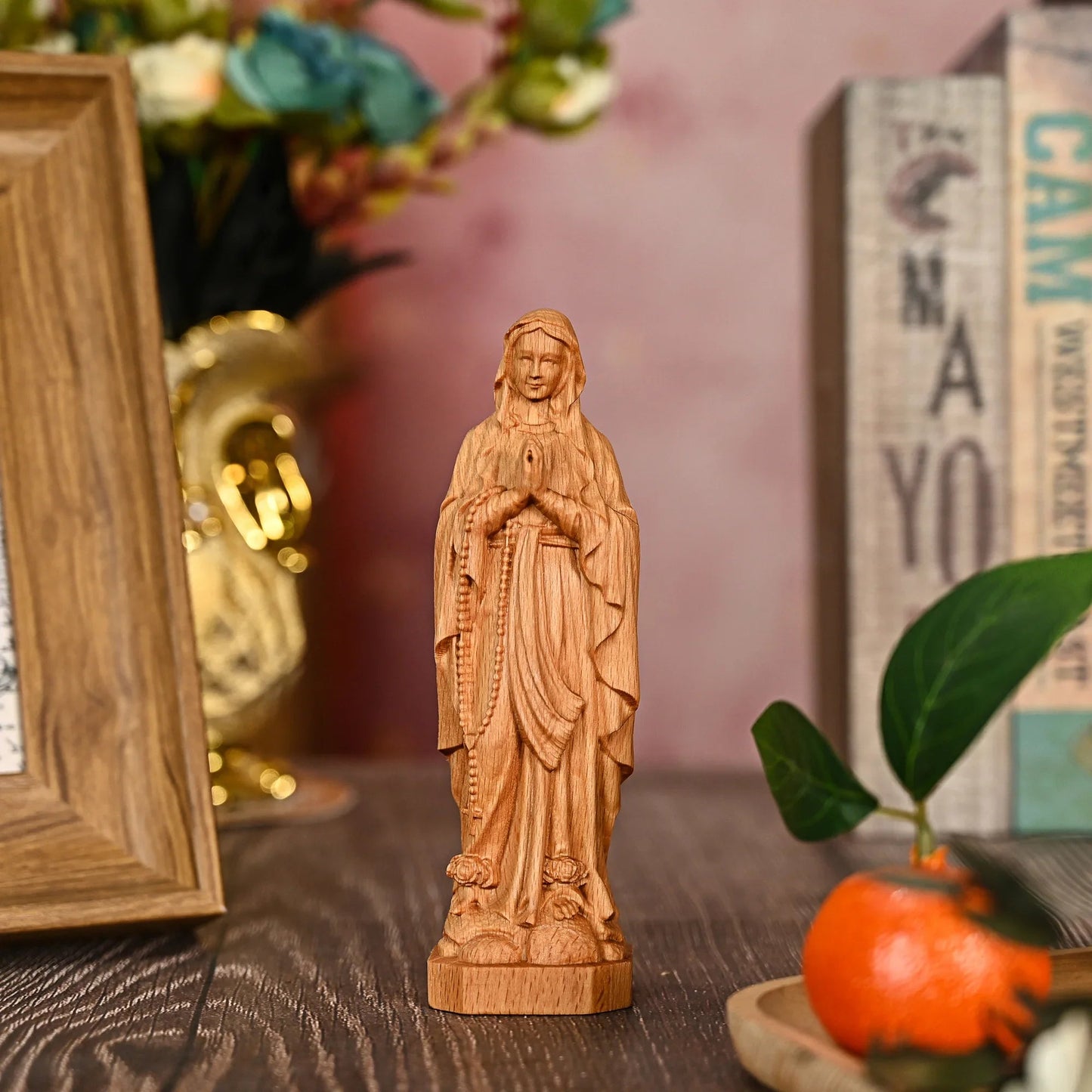 Our Lady of Lourdes in natural beech on a wooden table