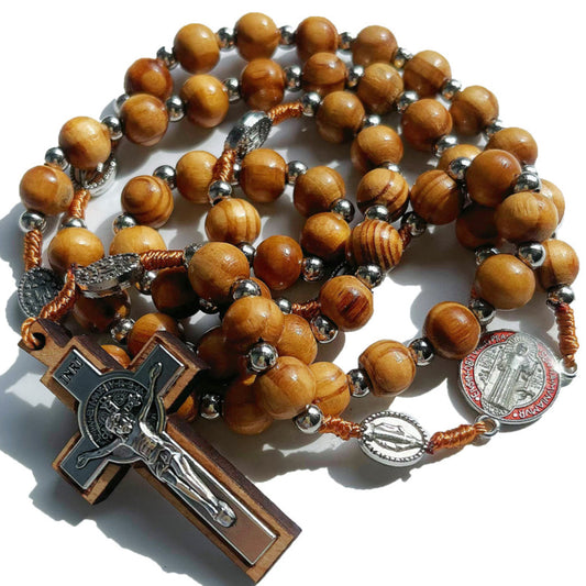 The St. Benedict rosary coiled, showing the carved wood beads and medal