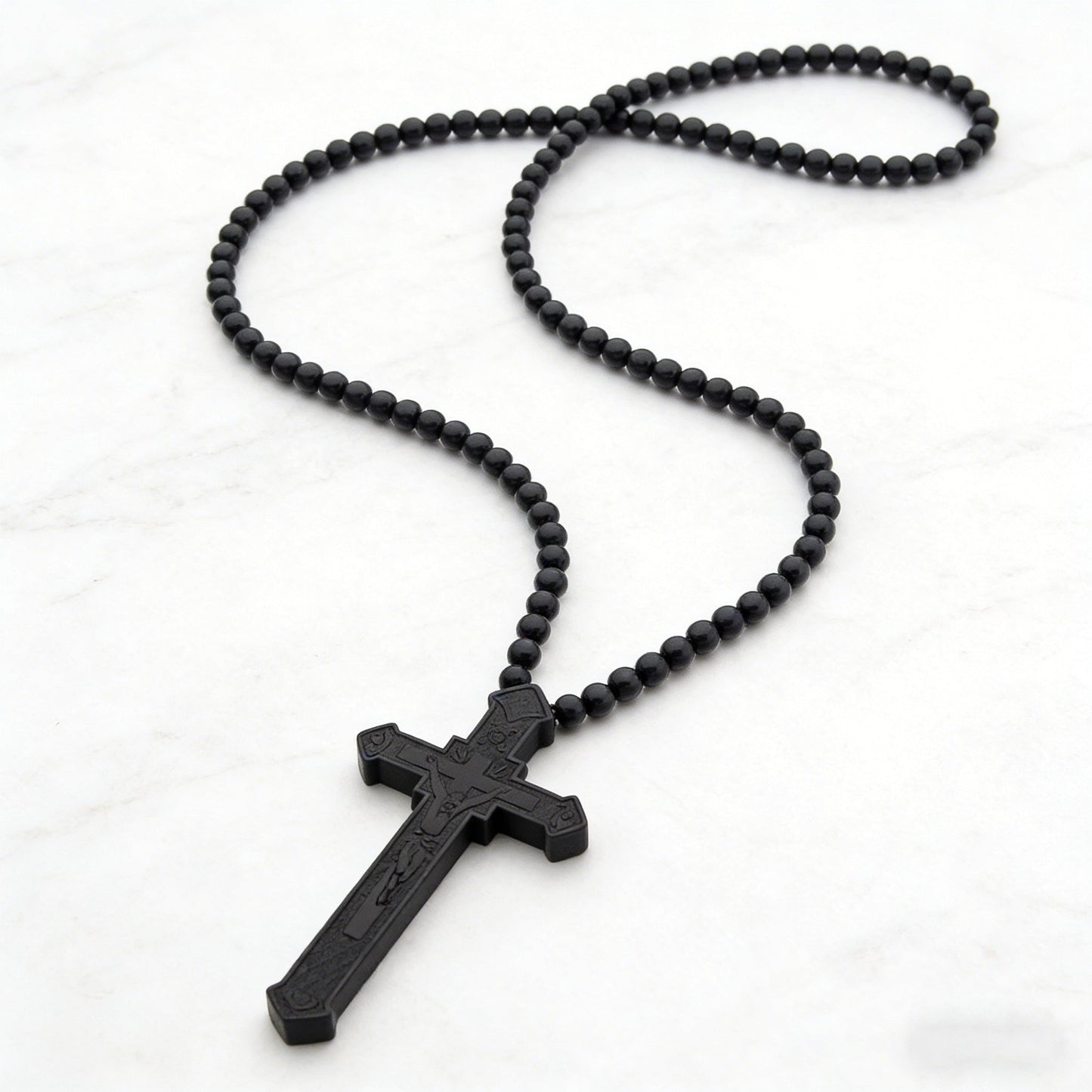 Black wooden bead rosary, coiled