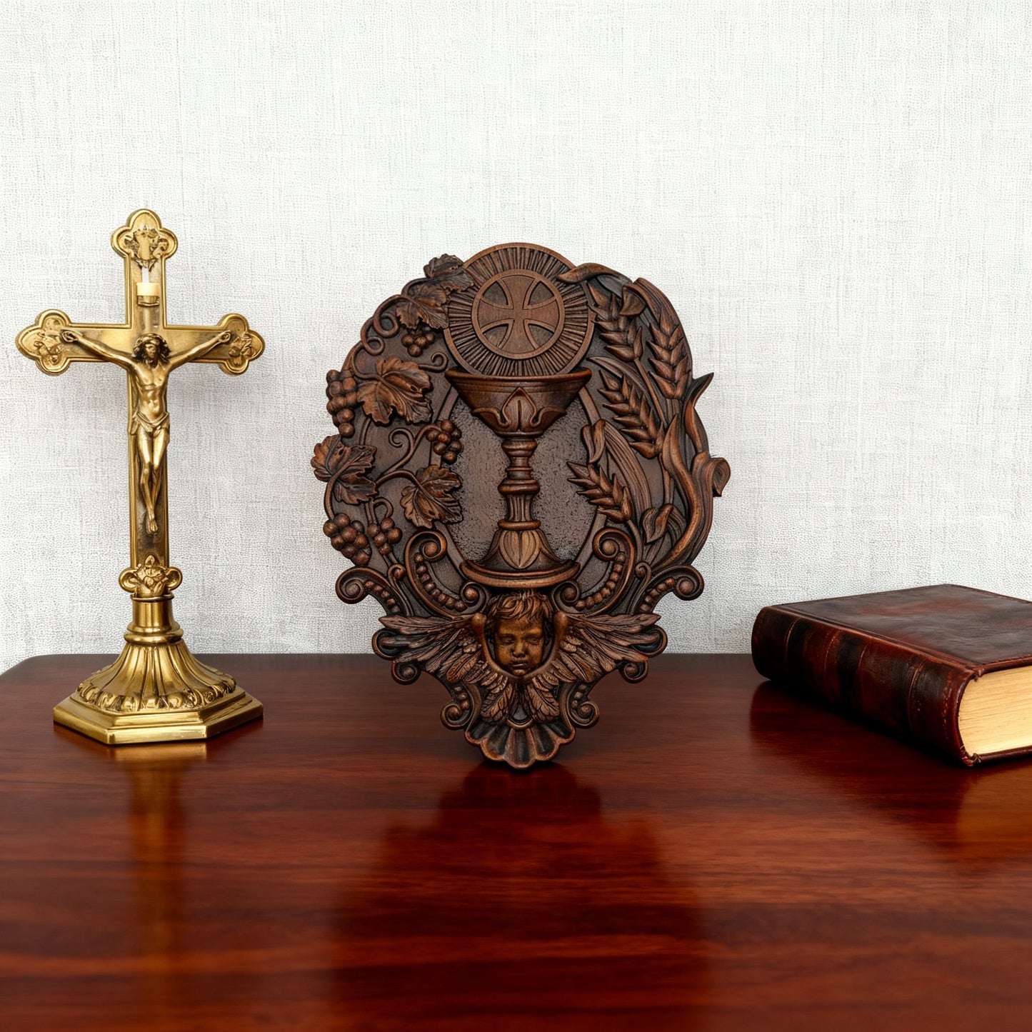 The carving on a desk beside a brass crucifix