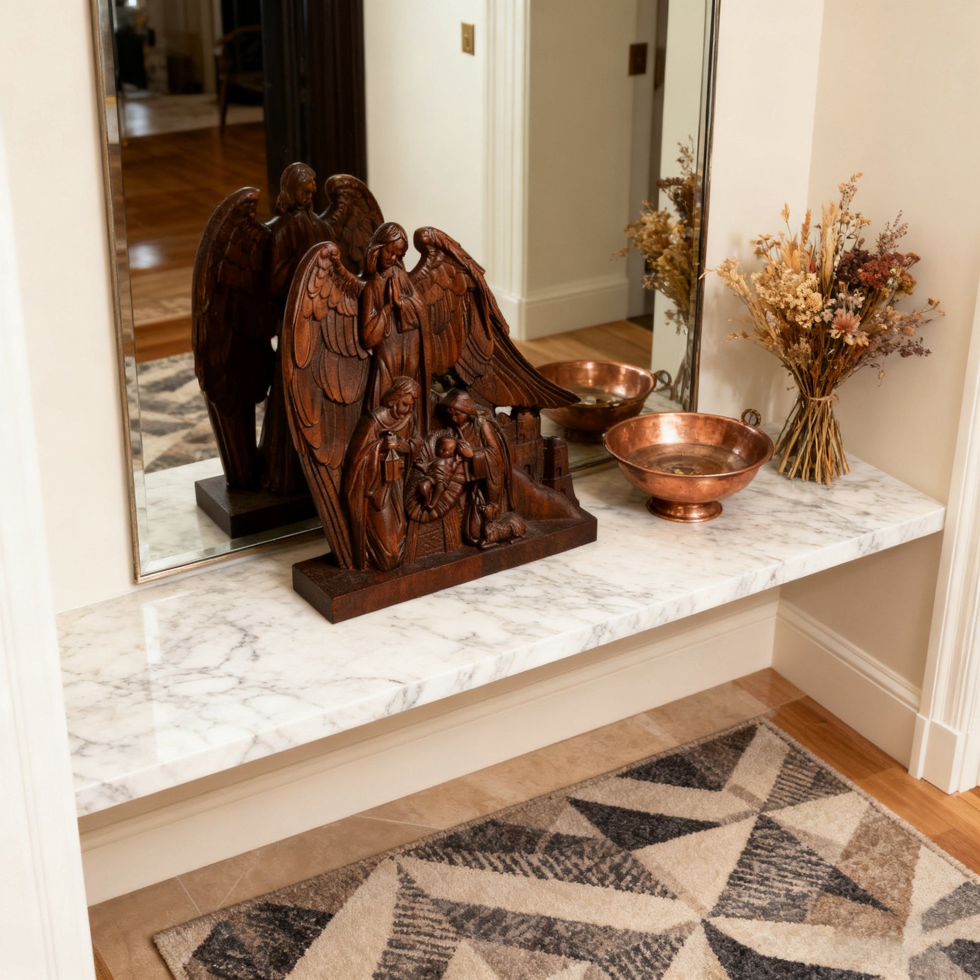 Holy Family with Guardian Angel statue on a marble mantel