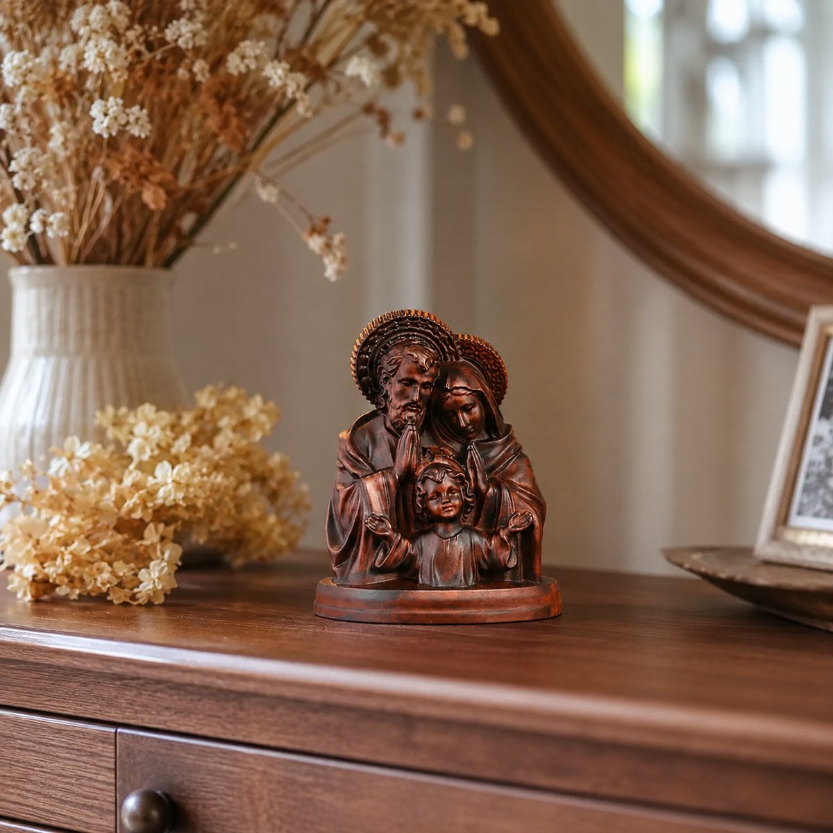The Holy Family carving on a dresser with dried flowers