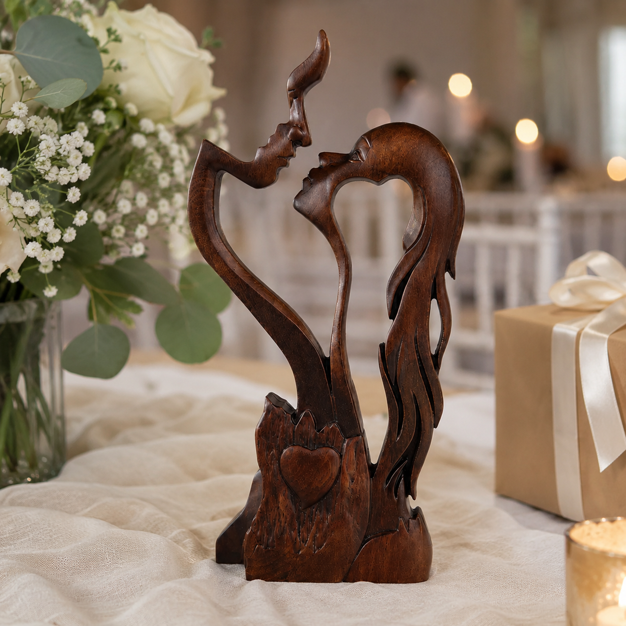 Love Eternal couple carving on a wedding table with baby's breath
