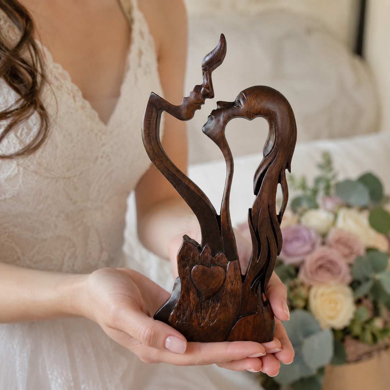 The bride holding the carving in her palm beside her bouquet