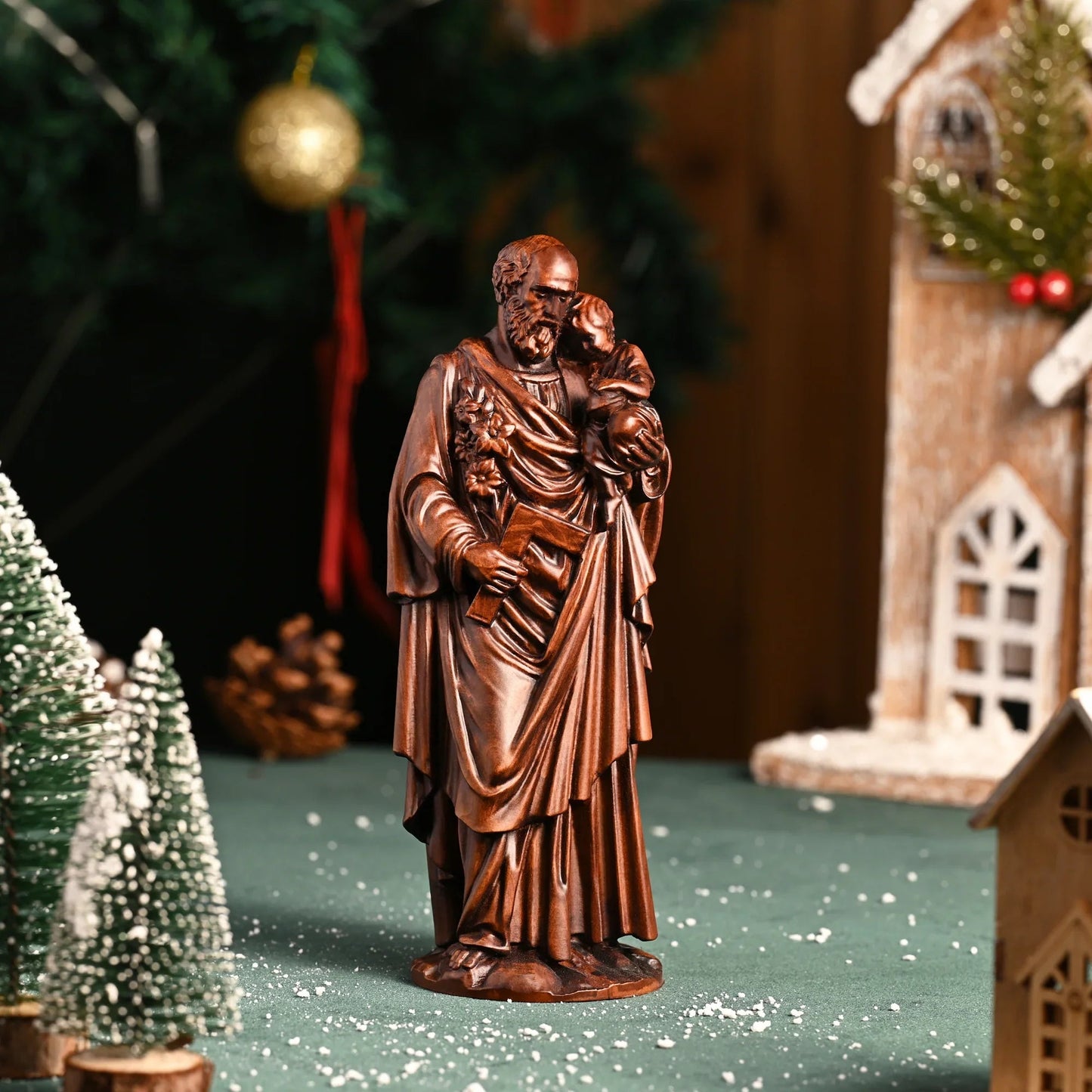 St. Joseph and the Child on a shelf with winter greenery